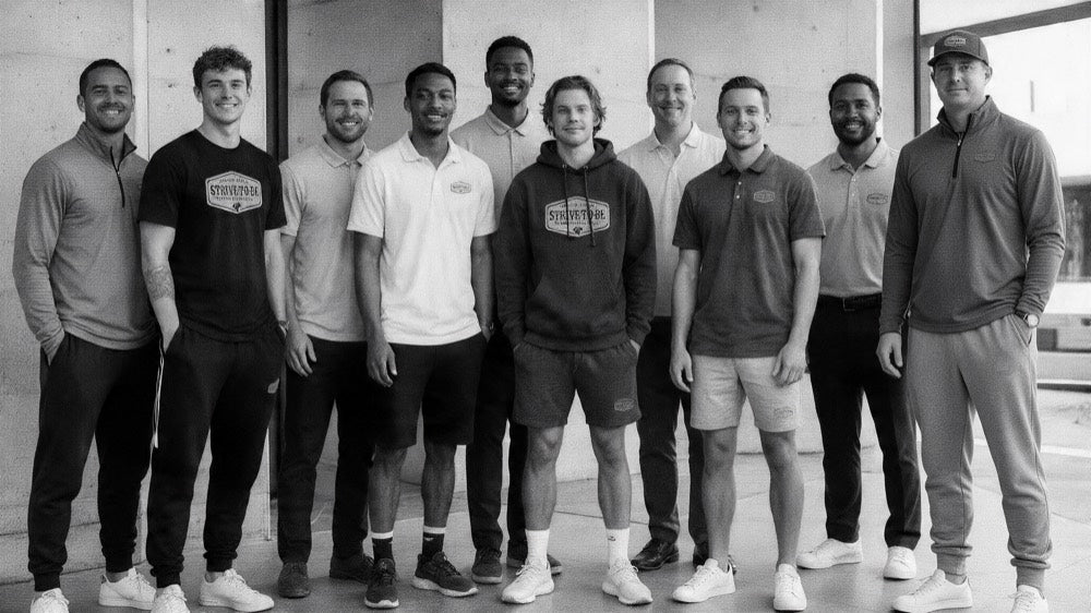 A team of ten in matching Strive-To-Be gear: quarter-zips, tees, polos, a hoodie, shorts, joggers, and a cap